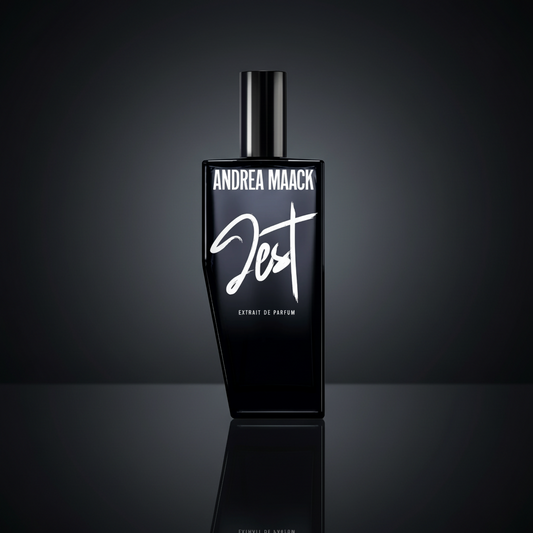 Black perfume bottle with 'Andrea Maack' branding on a white background