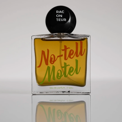 Perfume bottle labeled 'No-tell Motel' with a black cap on a reflective surface.